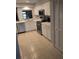 Bright kitchen with white cabinets, stainless steel appliances, and tile flooring at 721 Plumbrook Rd, Sun City Center, FL 33573