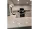 Updated kitchen with white cabinets, quartz counters, and breakfast bar at 721 Plumbrook Rd, Sun City Center, FL 33573
