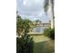 Peaceful lake view from the backyard, showcasing lush landscaping at 721 Plumbrook Rd, Sun City Center, FL 33573