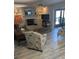 Spacious living room with seating, fireplace, and view to lanai at 721 Plumbrook Rd, Sun City Center, FL 33573
