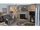 Cozy living room featuring a fireplace, built-in shelving, and comfy seating at 721 Plumbrook Rd, Sun City Center, FL 33573