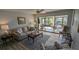 Living room with a view to a screened-in patio and water view at 721 Plumbrook Rd, Sun City Center, FL 33573