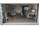 Bright living room with access to a screened patio and water view at 721 Plumbrook Rd, Sun City Center, FL 33573