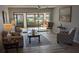Spacious living room with water view, laminate flooring, and comfy seating at 721 Plumbrook Rd, Sun City Center, FL 33573
