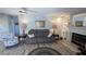 Living room with seating, built in shelving and fireplace at 721 Plumbrook Rd, Sun City Center, FL 33573