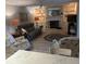 Open living room with seating, fireplace, and access to the lanai at 721 Plumbrook Rd, Sun City Center, FL 33573