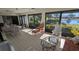 Sunroom with lake view, comfortable seating, and patio furniture at 721 Plumbrook Rd, Sun City Center, FL 33573