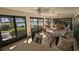 Bright sunroom with lake view, comfy seating, and patio furniture at 721 Plumbrook Rd, Sun City Center, FL 33573