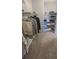 Well-organized walk-in closet with shelves and hanging rods at 721 Plumbrook Rd, Sun City Center, FL 33573