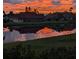 Dramatic sunset reflected in lake with homes visible at 721 Plumbrook Rd, Sun City Center, FL 33573