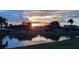 Sunset view over calm lake with homes along the shore at 721 Plumbrook Rd, Sun City Center, FL 33573