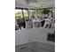 Sunroom features a wet bar with a quartz countertop and seating at 721 Plumbrook Rd, Sun City Center, FL 33573