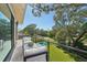 Private balcony with seating area and stunning backyard and pool views at 1630 Douglas Ave, Dunedin, FL 34698