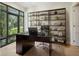 Spacious home office with built-in shelving and large windows at 1630 Douglas Ave, Dunedin, FL 34698