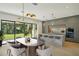Modern kitchen with island, sleek cabinetry, and breakfast area overlooking backyard at 1630 Douglas Ave, Dunedin, FL 34698