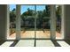 View of backyard through sliding glass doors, showcasing a deck at 15810 2Nd E St, Redington Beach, FL 33708