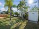 Fenced backyard with storage shed and tropical plants at 15810 2Nd E St, Redington Beach, FL 33708