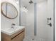 Updated bathroom with a walk-in shower and modern vanity at 15810 2Nd E St, Redington Beach, FL 33708