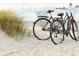 Two bicycles parked on a sandy beach near dunes at 15810 2Nd E St, Redington Beach, FL 33708