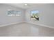 Bright bedroom with ceiling fan and large windows at 15810 2Nd E St, Redington Beach, FL 33708