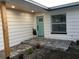 Renovated front entry with light teal door and gray pavers at 15810 2Nd E St, Redington Beach, FL 33708
