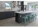 Modern kitchen with gray and white cabinets, marble countertops and island at 15810 2Nd E St, Redington Beach, FL 33708
