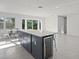 Open concept kitchen with marble countertops and island at 15810 2Nd E St, Redington Beach, FL 33708
