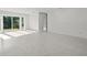 Spacious living area with light-colored flooring and sliding glass doors at 15810 2Nd E St, Redington Beach, FL 33708