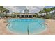 Community pool with lounge chairs and clubhouse at 2220 Kings Palace Dr, Riverview, FL 33578
