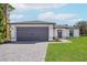 Newly constructed home with gray garage door and paver driveway at 13208 Foresman Blvd, Port Charlotte, FL 33981