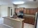 Well-equipped kitchen with an island and stainless steel appliances at 8115 Alamosa Wood Ave, Ruskin, FL 33573