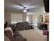 Spacious living room with ample seating and large windows at 8115 Alamosa Wood Ave, Ruskin, FL 33573