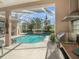 View of the refreshing pool and adjacent outdoor kitchen at 331 Lewis Rd, Lithia, FL 33547