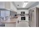 Kitchen with white cabinets, stainless steel appliances, and a breakfast bar at 1013 Apollo Beach Blvd # 202, Apollo Beach, FL 33572