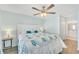 Main bedroom with king-size bed and ceiling fan at 1013 Apollo Beach Blvd # 202, Apollo Beach, FL 33572