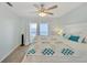 Main bedroom with king-size bed, ceiling fan, and access to balcony at 1013 Apollo Beach Blvd # 202, Apollo Beach, FL 33572