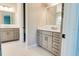 Bathroom with gray vanity, quartz countertop, and geometric floor tile at 430 Columbia Dr, Tampa, FL 33606