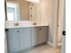 Elegant bathroom with gray double vanity, quartz countertop, and geometric floor tile at 430 Columbia Dr, Tampa, FL 33606