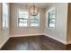 Spacious dining area with hardwood floors and a large globe chandelier at 430 Columbia Dr, Tampa, FL 33606