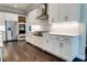 Modern kitchen with white cabinets, stainless steel appliances, and dark hardwood floors at 430 Columbia Dr, Tampa, FL 33606