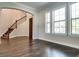 Living room with dark hardwood floors and grand staircase at 430 Columbia Dr, Tampa, FL 33606