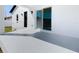 Covered back patio with concrete flooring and white vinyl fence at 206 S Water St, Plant City, FL 33563