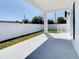 Private backyard with covered patio and white vinyl fence at 206 S Water St, Plant City, FL 33563