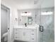 Modern bathroom with white vanity, marble shower, and black accents at 206 S Water St, Plant City, FL 33563