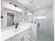 Bathroom with marble shower, white vanity, and grey floor at 206 S Water St, Plant City, FL 33563