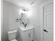 Small bathroom with white vanity and toilet at 206 S Water St, Plant City, FL 33563