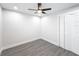 Bright bedroom with ceiling fan and grey wood-look floors at 206 S Water St, Plant City, FL 33563