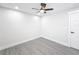 Bedroom with ceiling fan and grey wood-look floors at 206 S Water St, Plant City, FL 33563