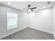 Spacious bedroom with large window and ceiling fan at 206 S Water St, Plant City, FL 33563
