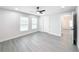 Bedroom with two windows, ceiling fan, and access to bathroom at 206 S Water St, Plant City, FL 33563